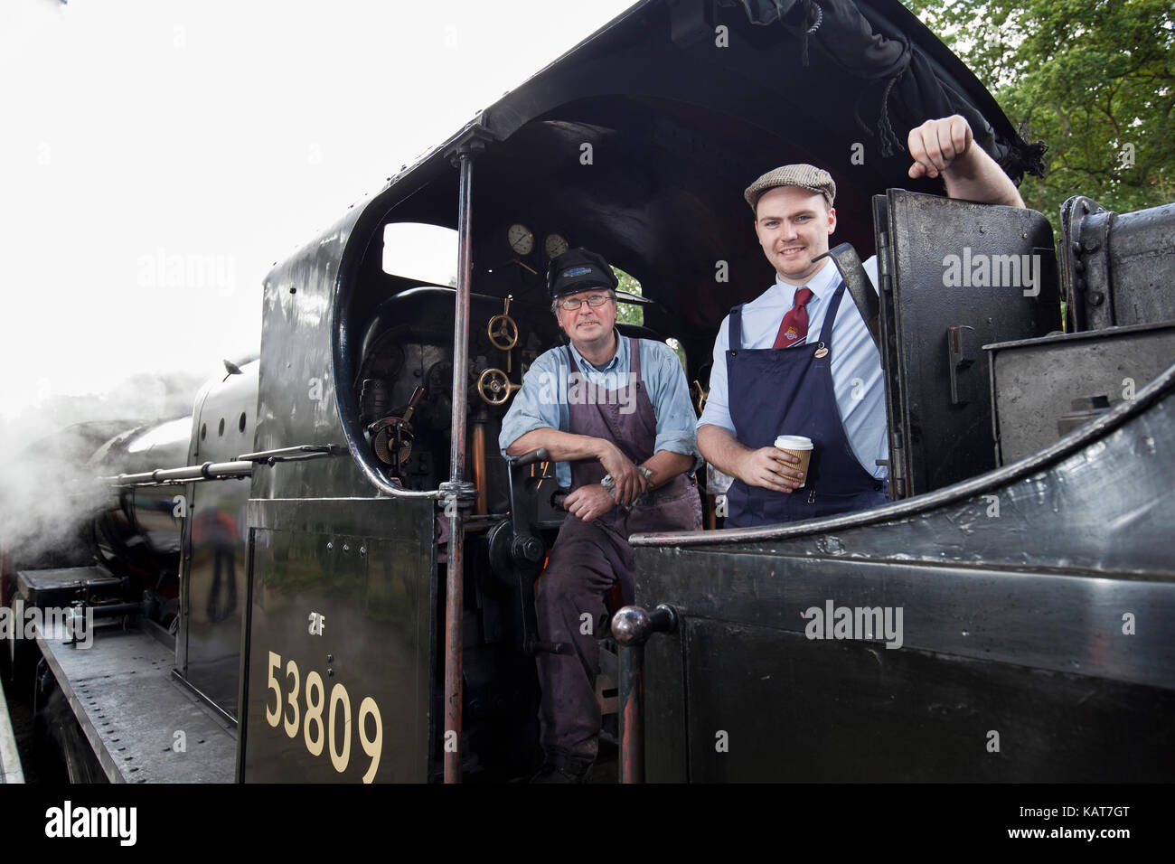 North Norfolk Railway steam engine driver and fireman take a break at Holt station on the Poppy Line. Stock Photo
