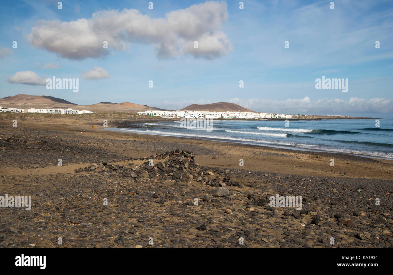 White cuboid buildings of coastal village La Caleta de Famara, Lanzarote, Canary islands, Spain Stock Photo