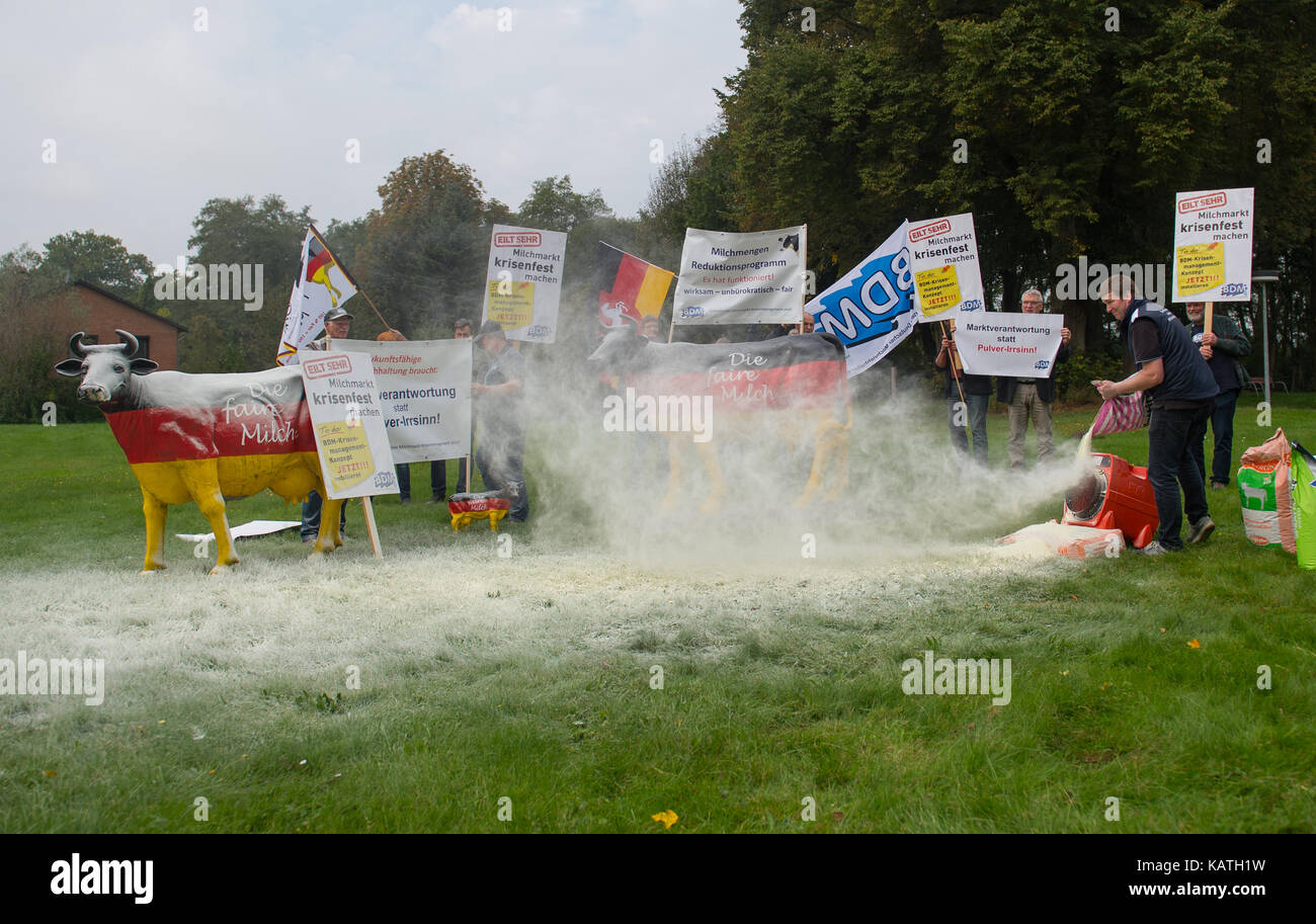 Dairy farmers blow milk powder over a meadow in Neetze, Germany, 27 September 2017. Milk powder was blown into the air on a meadow in Neetze near Lueneburg with the motto 'Market responsibilty instead of powder nonsense'. Photo: Philipp Schulze/dpa Stock Photo