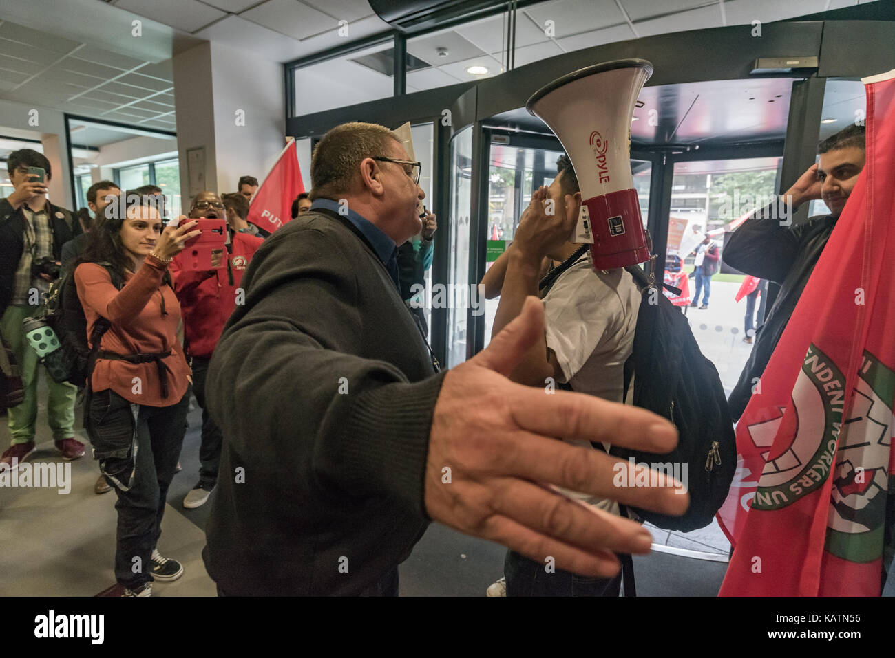 London, UK. 27th Sep, 2017. A security man tells Independent Workers Union of Great Britain President Henry Chango Lopez that the protesters must leave the lobby of Birkbeck College where they are holding a noisy protest. The workers include security staff who have not received the increases in salary promised to maintain differentials since 2011. Credit: ZUMA Press, Inc./Alamy Live News Stock Photo