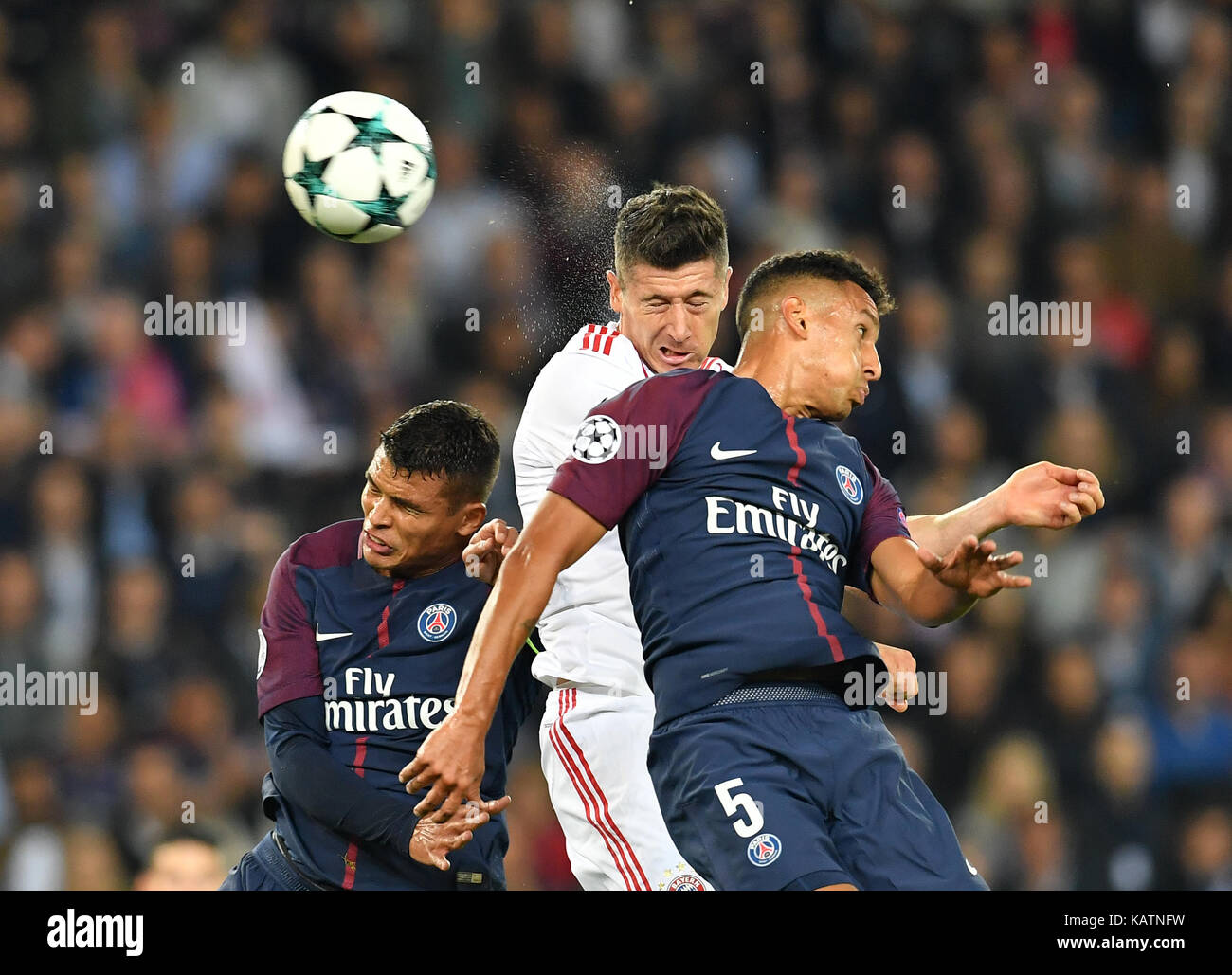 Paris, France. 27th Sep, 2017. Robert Lewandowski (c) of Bayern and Thiago Silva (l) and Marquinhos of Paris vie for the ball during the Champions League football match between Paris St. Germain and Bayern Munich at the Parc des Princes stadium in Paris, France, 27 September 2017. Credit: Peter Kneffel/dpa/Alamy Live News Stock Photo