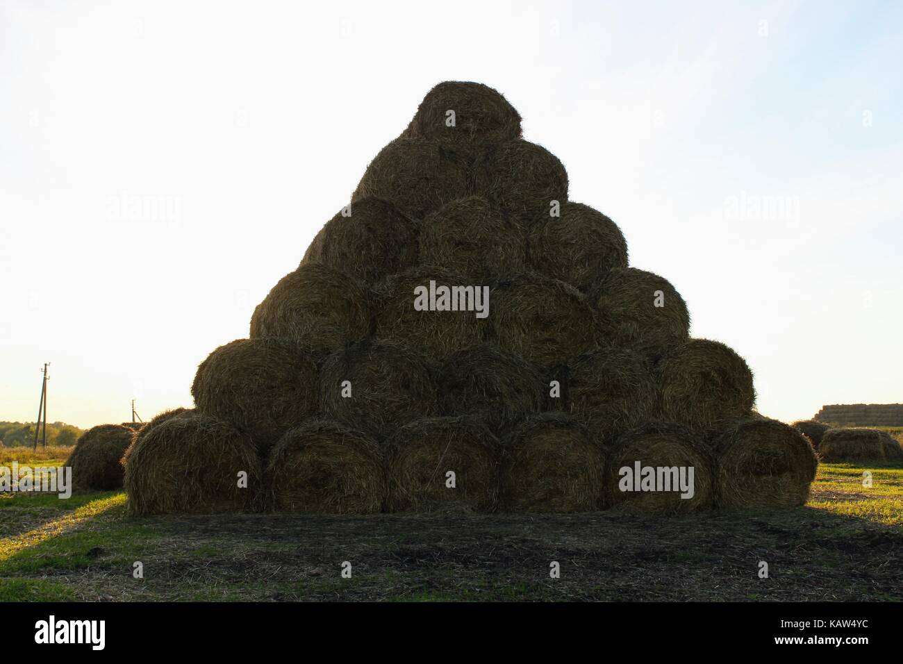 The pyramid is composed of hay balls in the rays of sunset Stock Photo ...