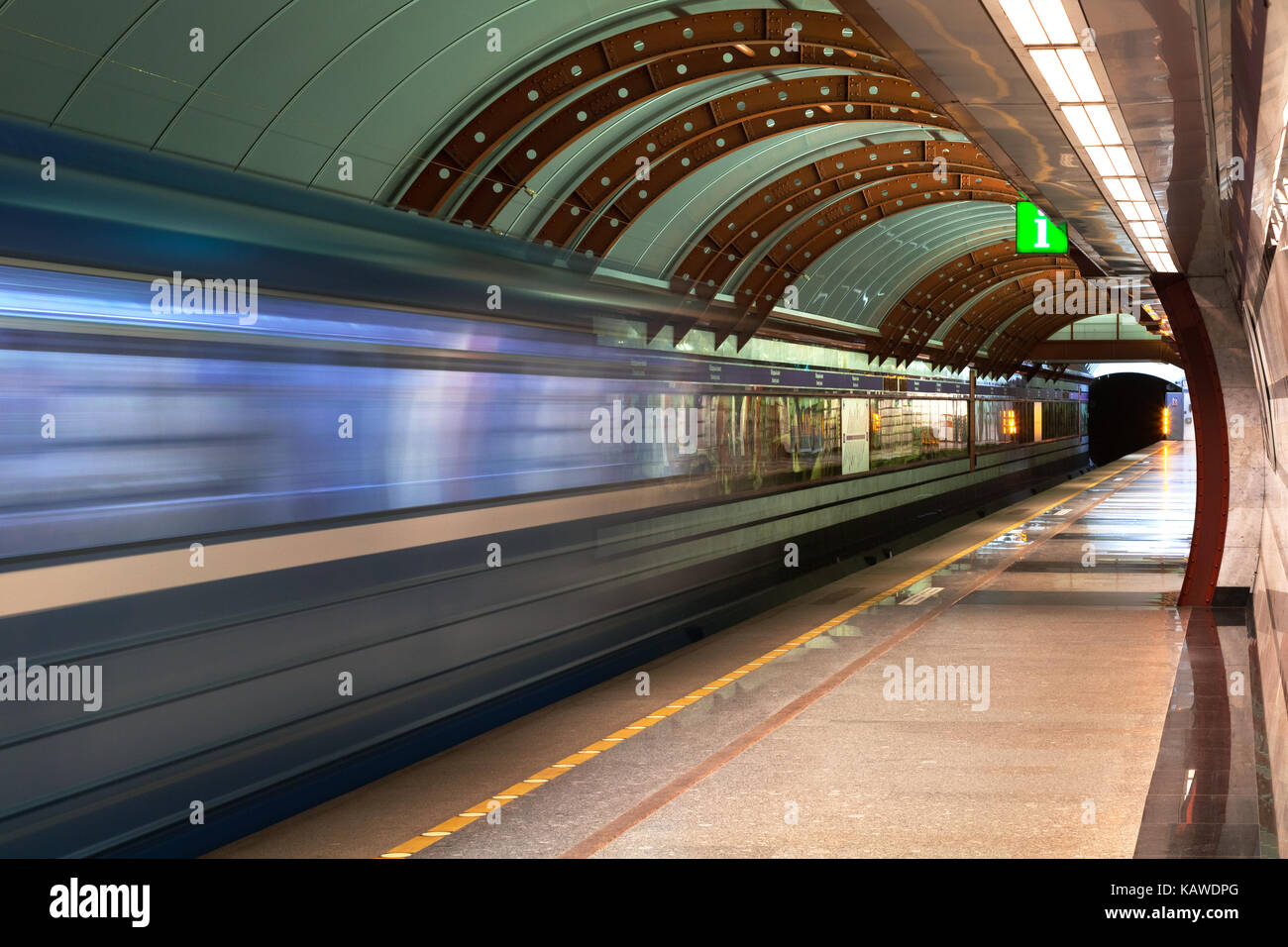 Subway station. Diagonal blue motion blur metro train background. Train departure. Fast underground subway train while hurtling fast with commuters on board. Stock Photo