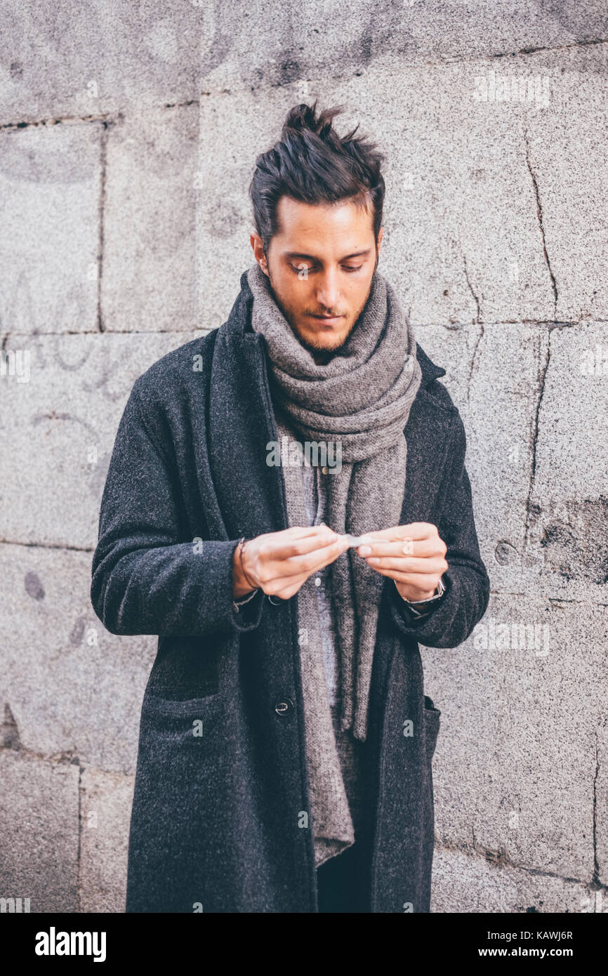 Young man smoking // Street style in Madrid Stock Photo