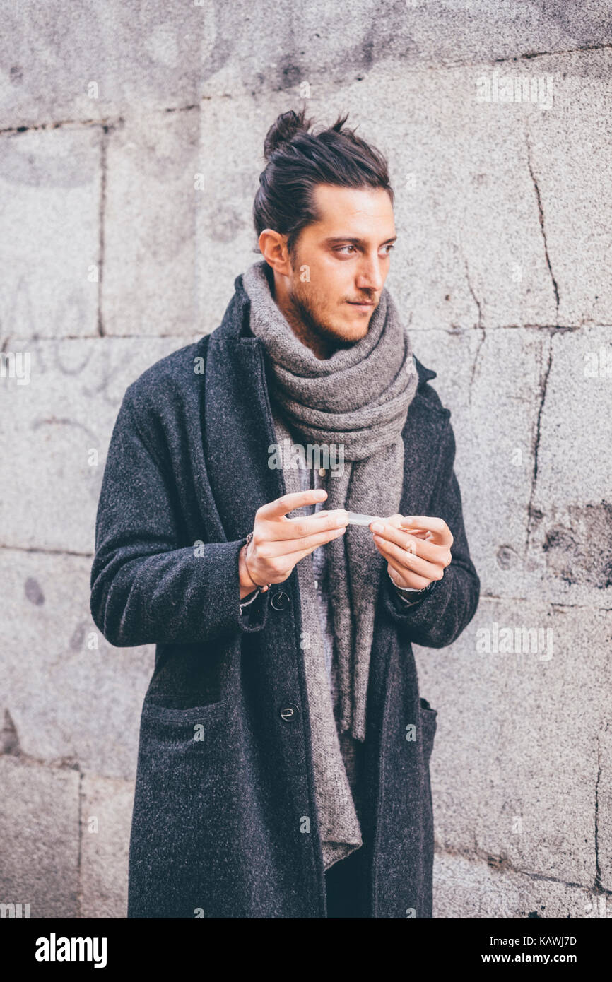 Young man smoking // Street style in Madrid Stock Photo