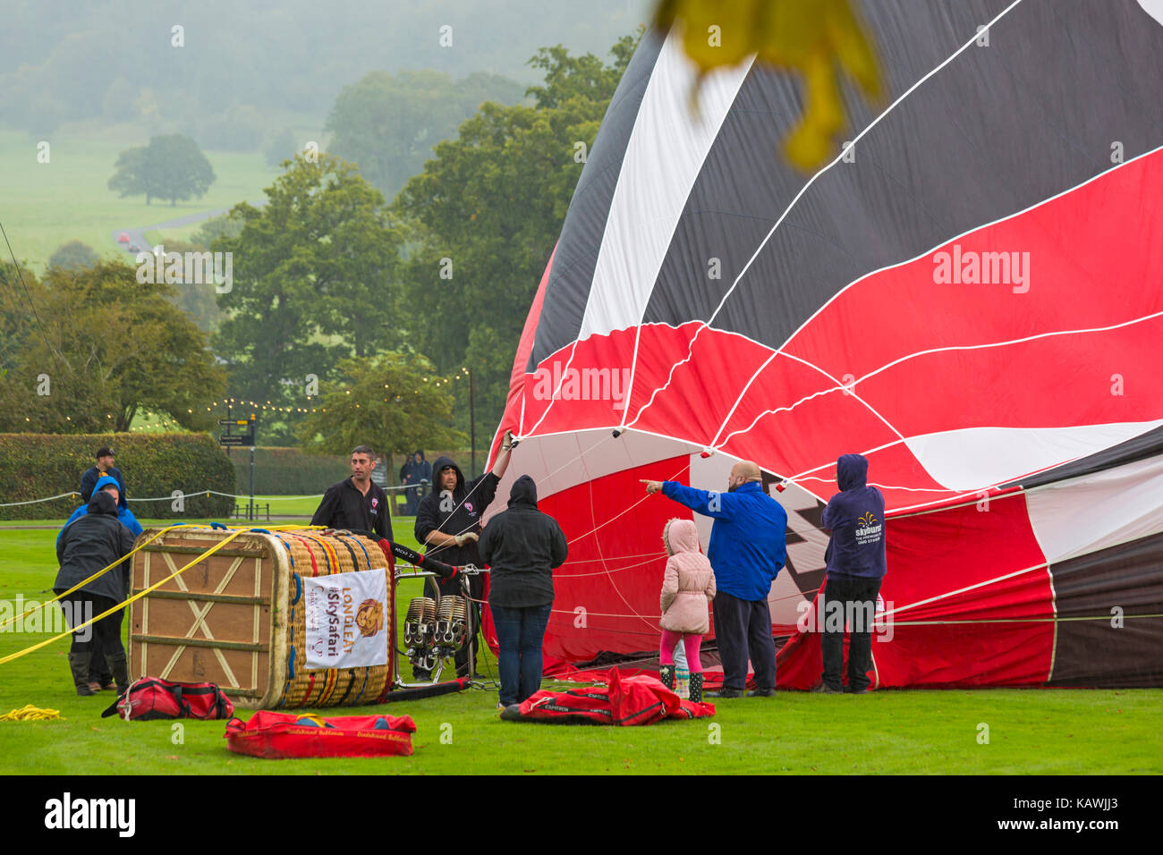 People around basket of hot air balloon on ground being inflated at Sky Safari hot air balloons at Longleat, Wiltshire UK in September Stock Photo