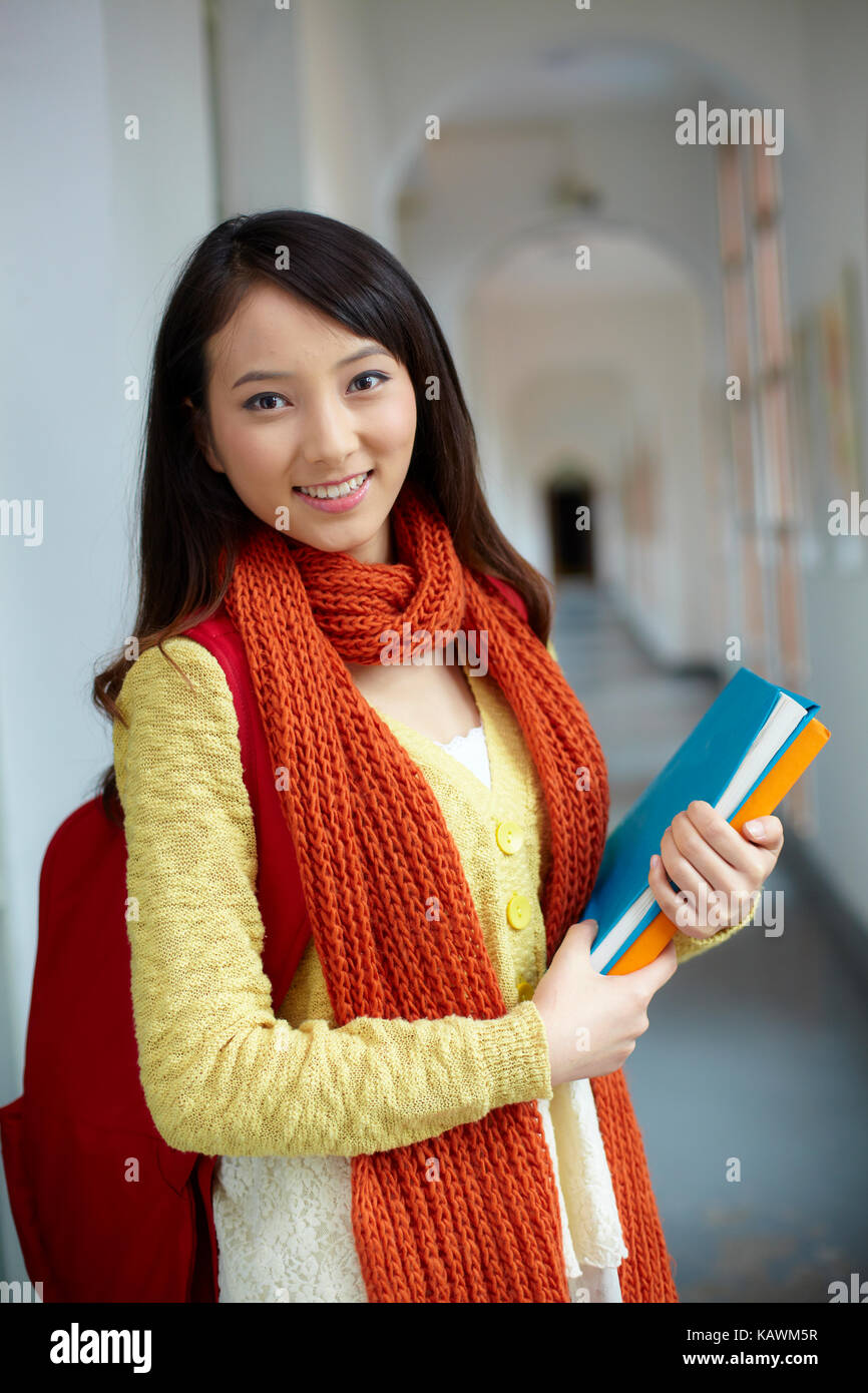 one pretty Chinese asian college student smile at camera in campus Stock Photo