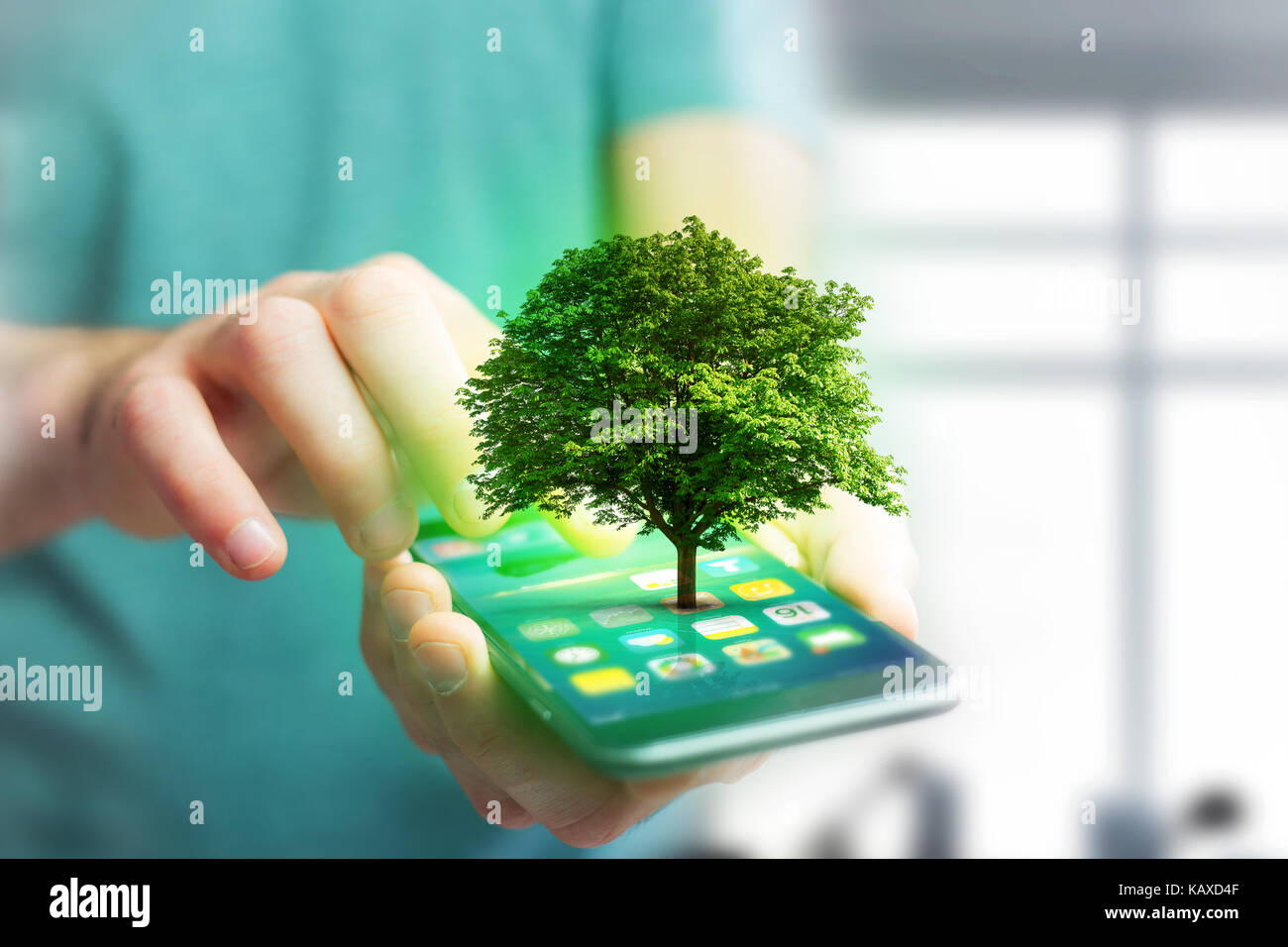 View of a Green tree going out of a smartphone - Ecology concept Stock ...