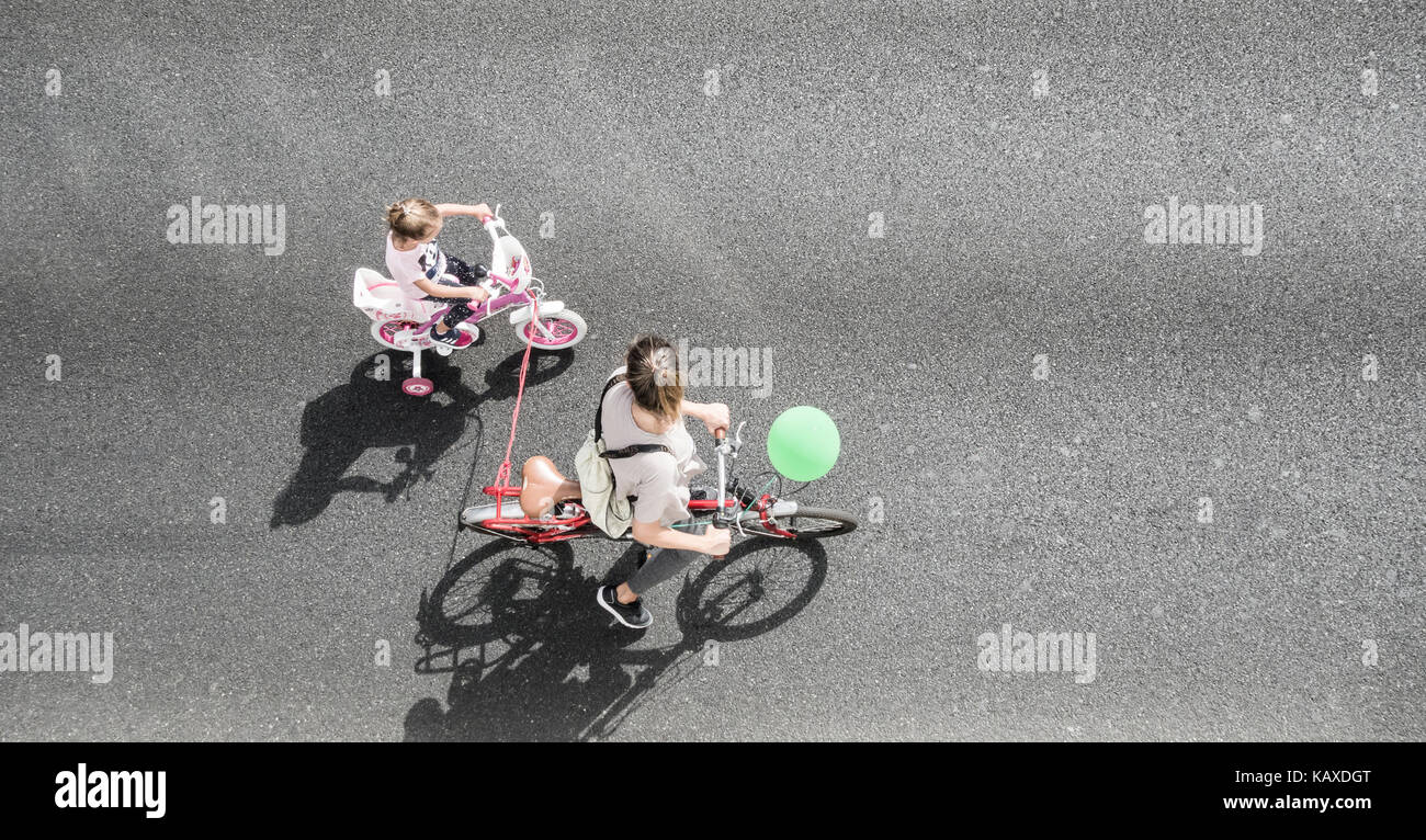 Overhead view of child learning to ride bicycle. Stock Photo