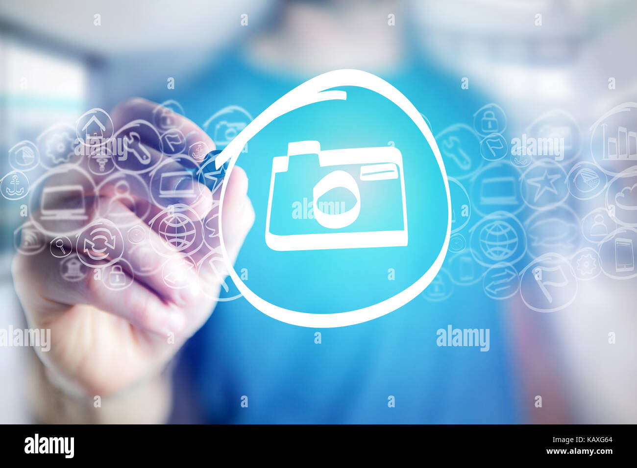 View of a Camera icon being drawn by a man on a virtual interface ...