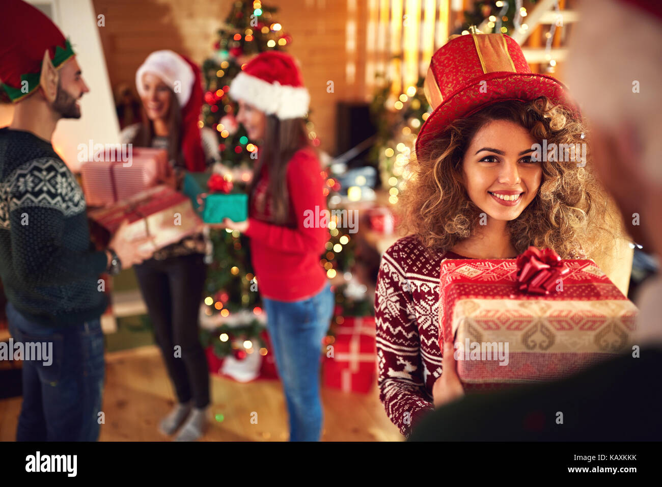 Friends giving gifts for Christmas Stock Photo - Alamy