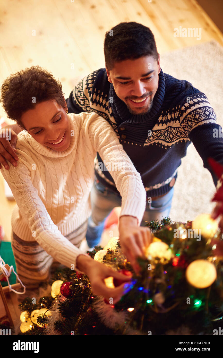 smiling family decorating Christmas tree at home Stock Photo