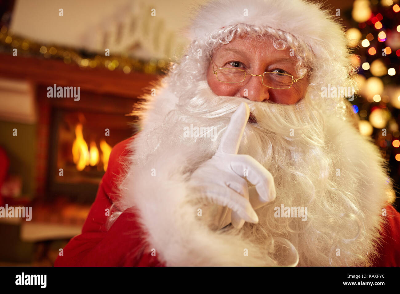 Santa holding a finger to his mouth, silence for Christmastime Stock Photo