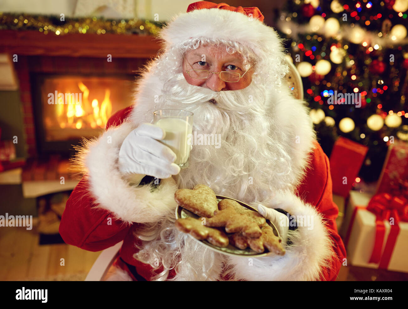 Santa Claus enjoying in cookies and milk on xmas Stock Photo Alamy