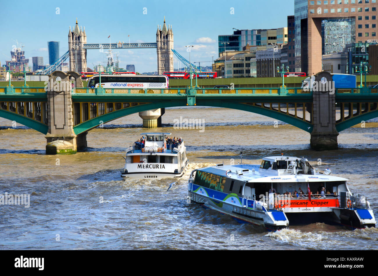London, England, UK. River transport - Mercuria (Thames River Services) and Hurricane Clipper heading (Thames Clippers) towards Tower Bridge - Nationa Stock Photo