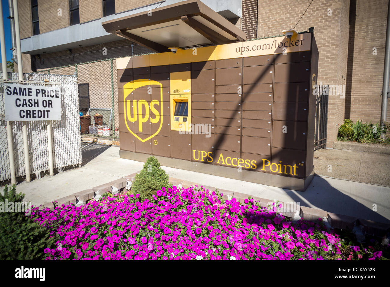 A UPS Access Point pick-up station in outside of a gas station in the Greenpoint neighborhood of New York on Saturday, September 23, 2017. The lockers enable customers, who work and do not have doorman or another party, to receive their purchase in a secure location. Amazon has had a similar network of lockers for several years. (© Richard B. Levine) Stock Photo