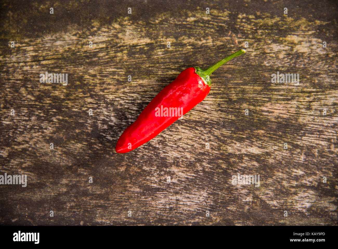 Red Chilli Pepper on a Wooden Background Stock Photo - Alamy