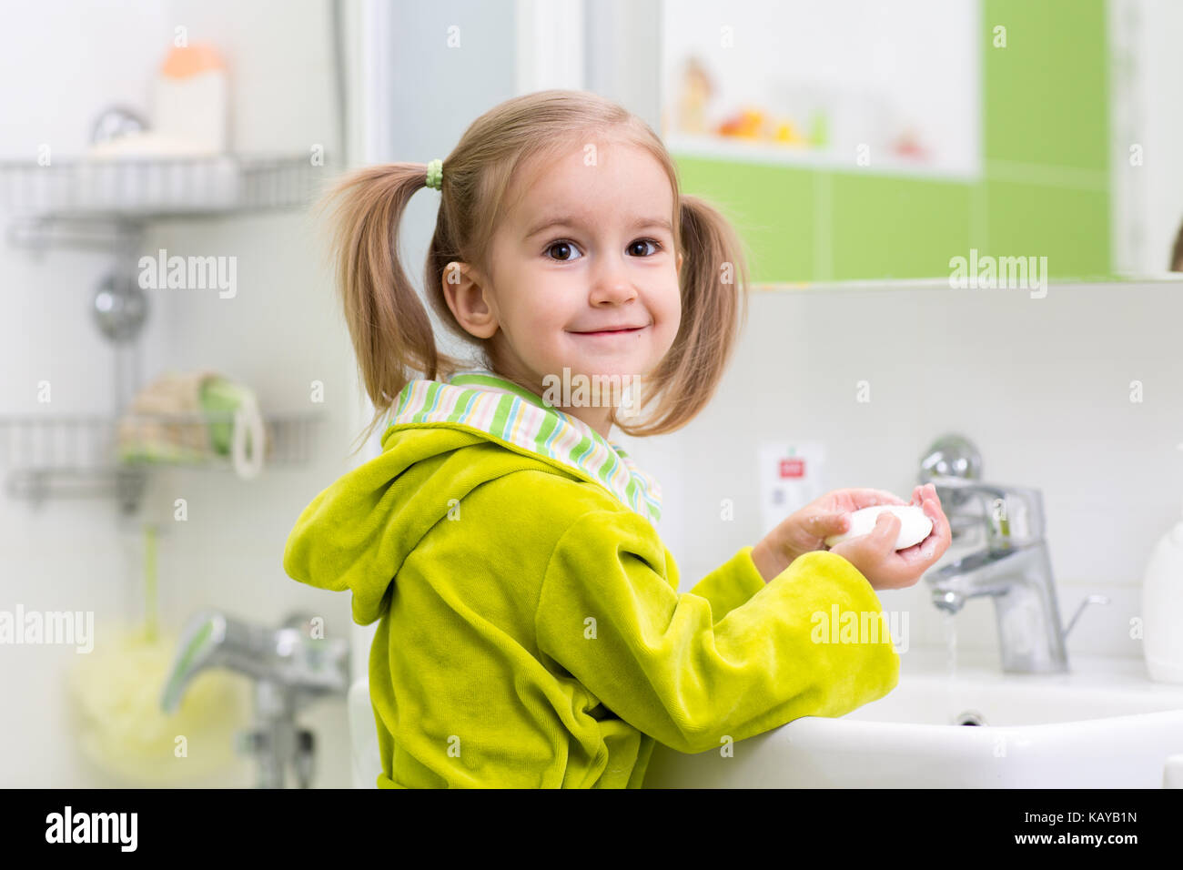 Little girl is washing her hands in the bathroom Stock Photo - Alamy