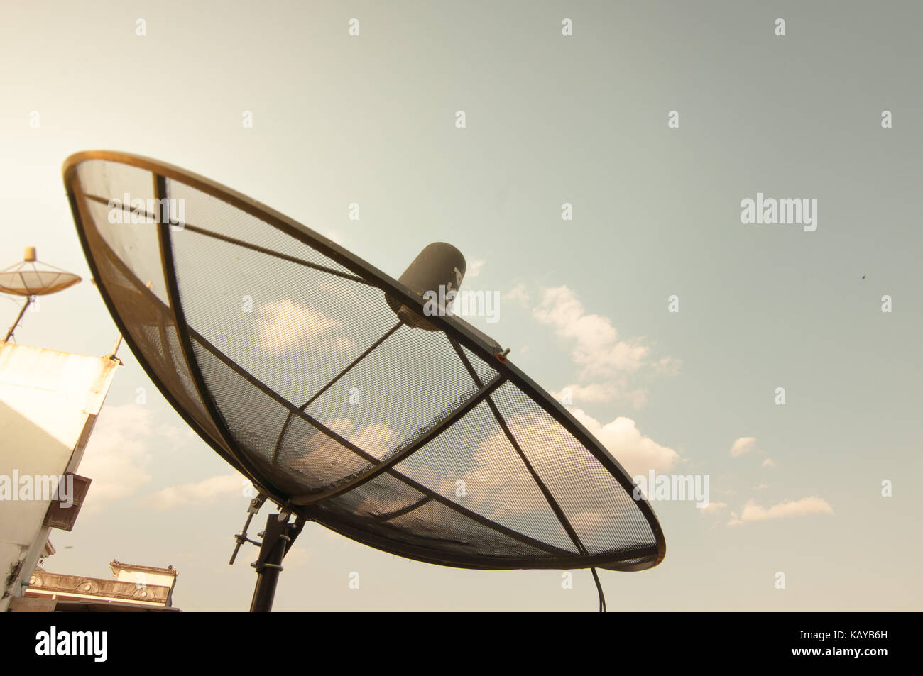 Receiver satlelite on a roof with Blue sky cloudy backgrounds Stock Photo