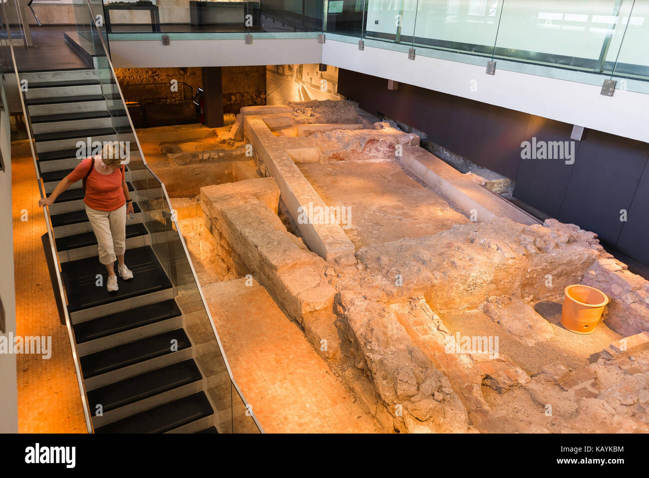 Valencia Spain L'Almoina, a visitor to the Almoina archaeological museum in Valencia descends below ground level to view excavated Roman buildings. Stock Photo