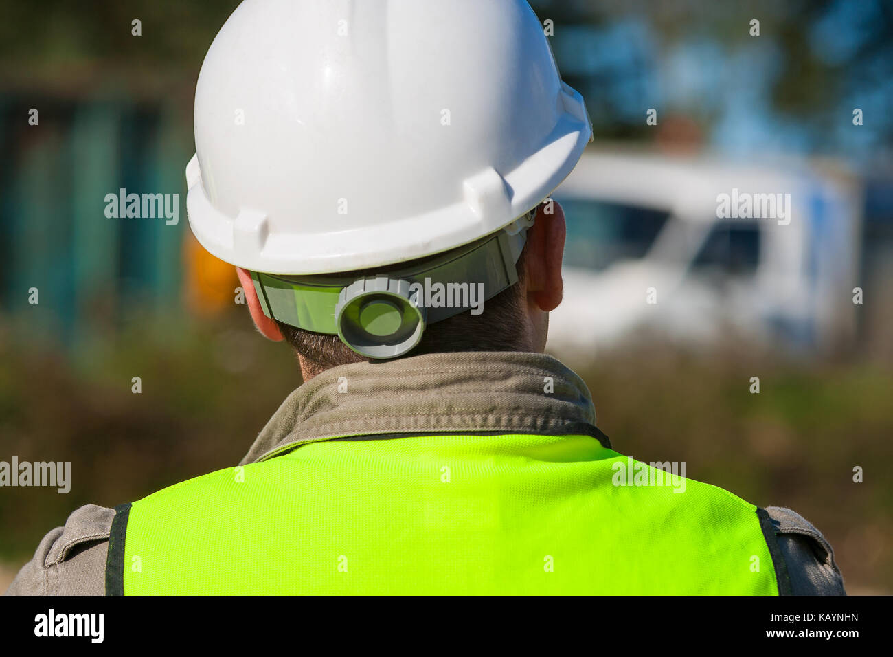 Rear view of construction worker on a building site and dressed in ...