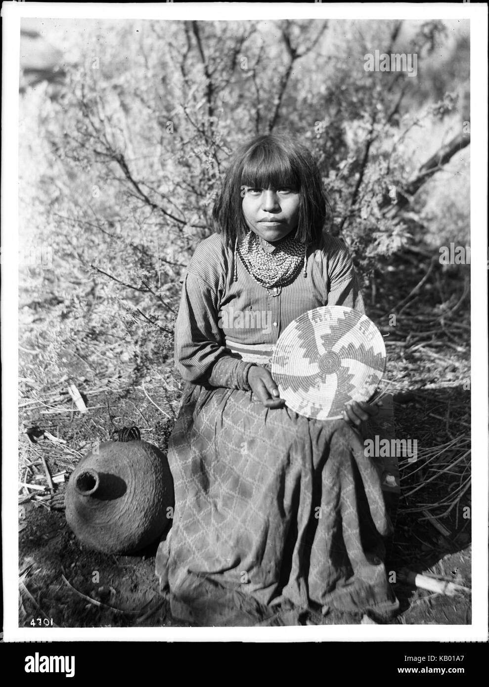 The Havasupai Indian Waluthama's daughter showing basket she made, ca