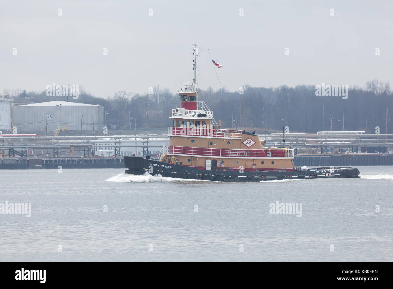 SEWAREN, NEW JERSEY - April 5, 2017: The Matthew Tibbetts tugboat works along the Arthur Kill on a hazy spring day. Stock Photo