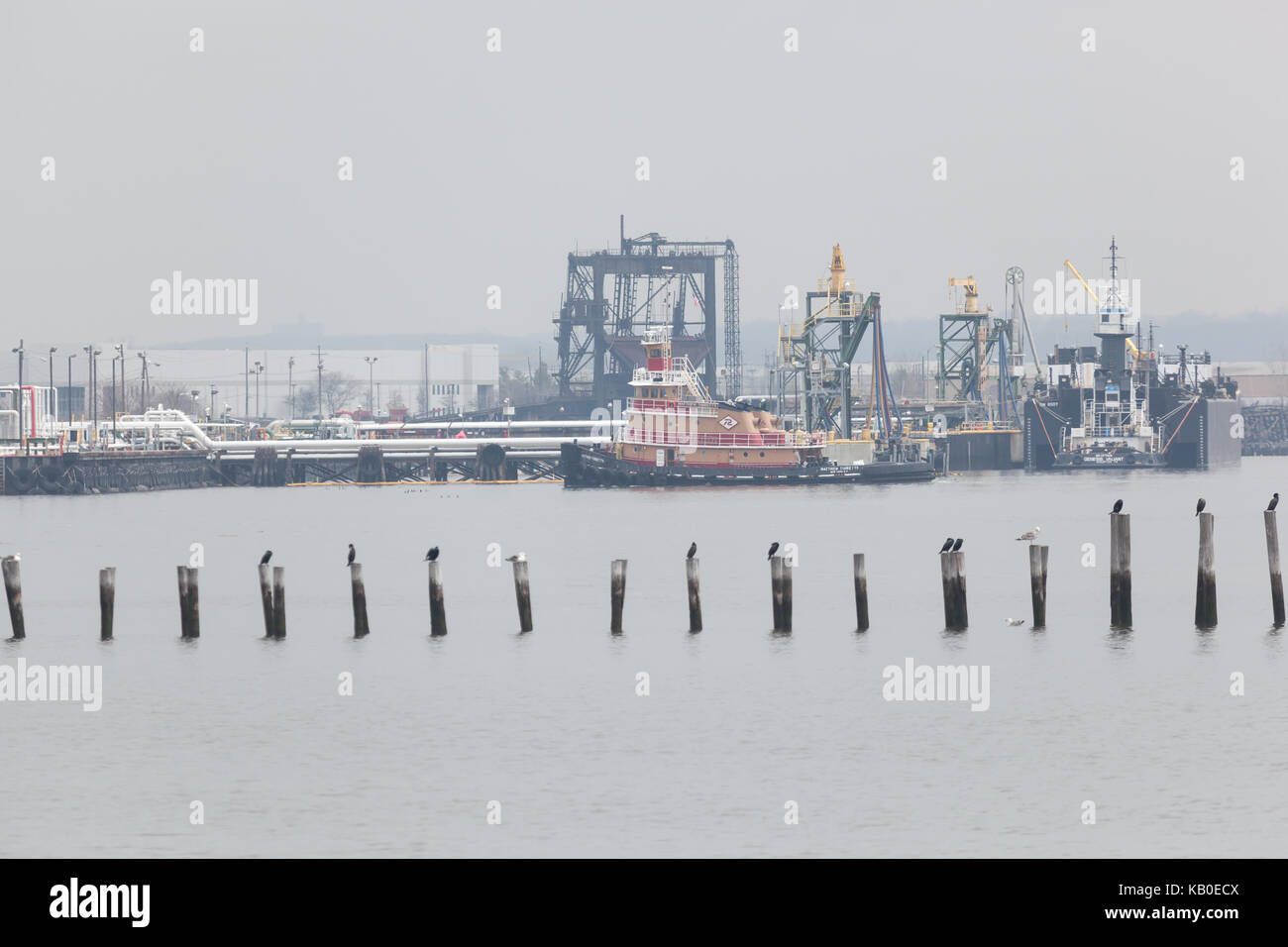 SEWAREN, NEW JERSEY - April 5, 2017: The Matthew Tibbetts tugboat works along the Arthur Kill on a hazy spring day. Stock Photo