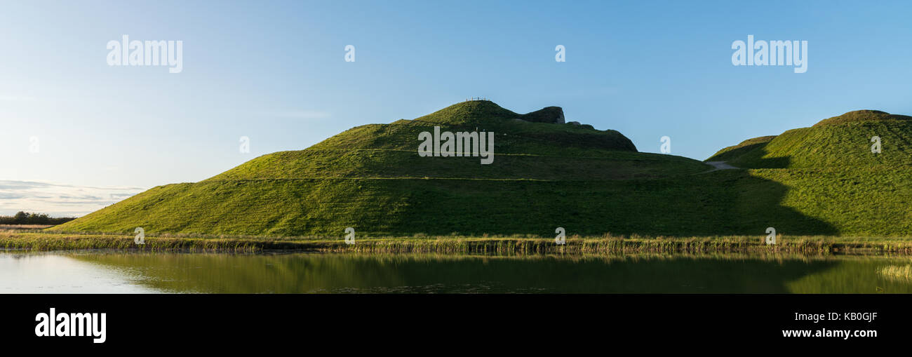 Taken at Northumberlandia in Cramlington, Northumberland UK. Showing the largest landform sculpture in the world, reflected in a lake. Stock Photo