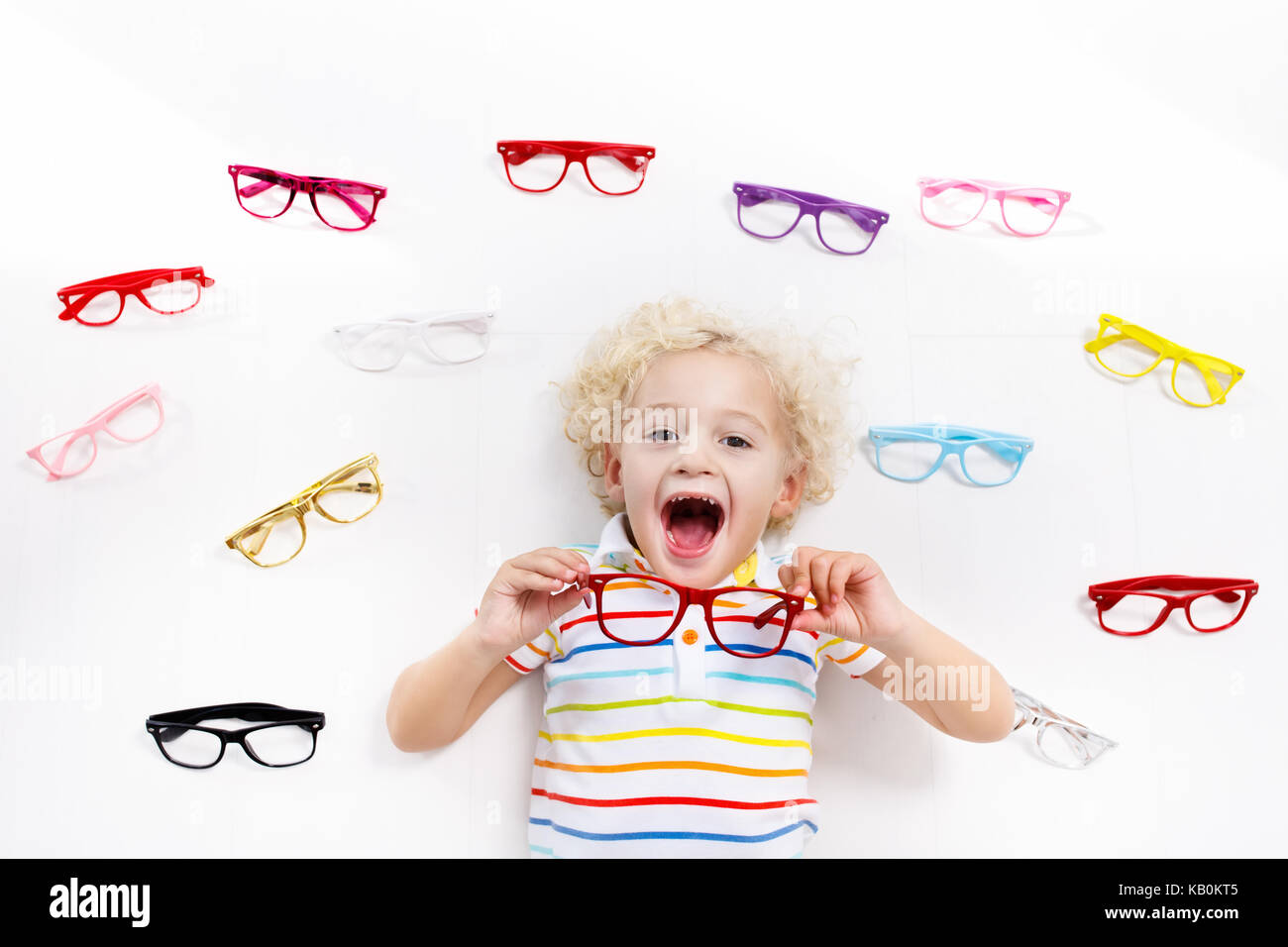 Child at eye sight test. Little kid selecting glasses at optician store. Eyesight measurement for school kids. Eye wear for children. Doctor performin Stock Photo
