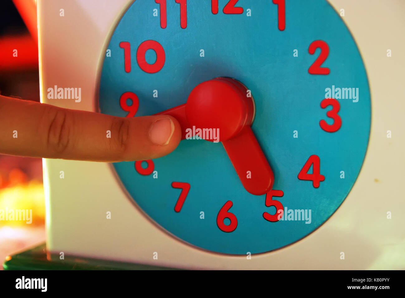 Child adjusting clock. Kids clock toy Stock Photo Alamy