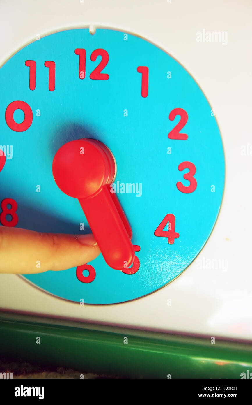 Child adjusting clock. Kids clock toy Stock Photo Alamy