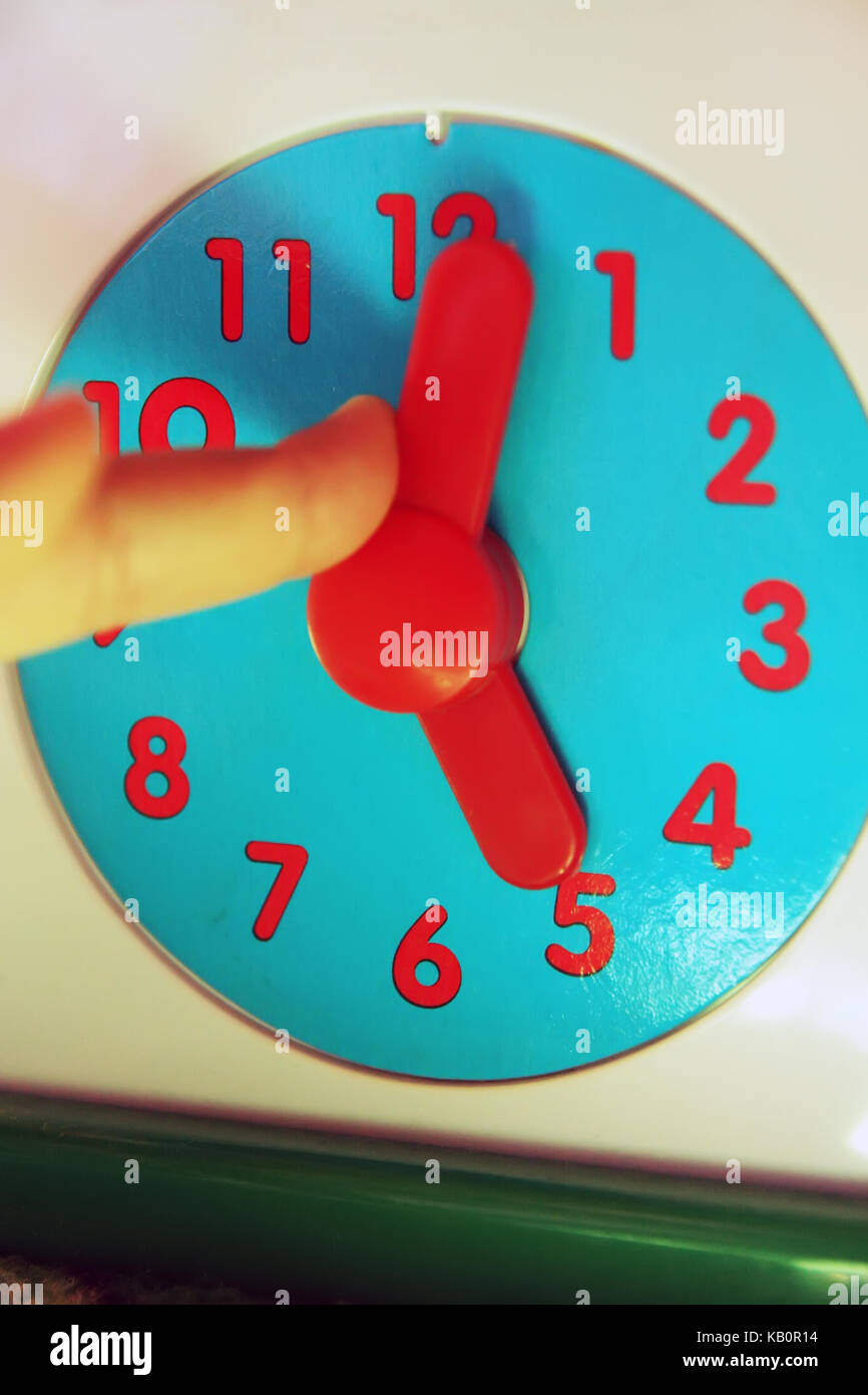 Child adjusting clock. Kids clock toy Stock Photo Alamy