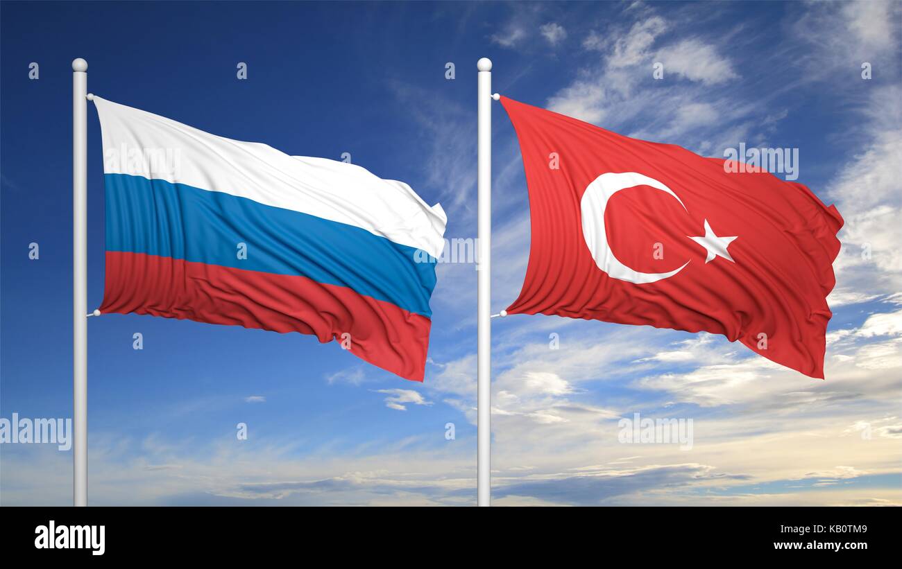 Turkish and Russian flags waving against of blue sky Stock Photo
