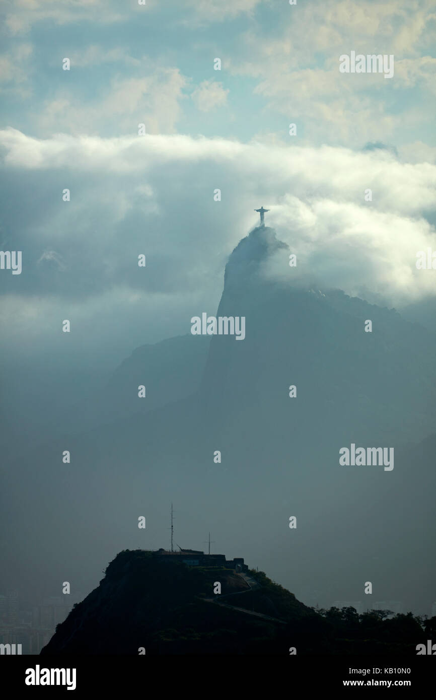 Christ the Redeemer in the clouds atop Corcovado, seen from Niteroi City Park, Niteroi, Rio de Janeiro, Brazil, South America Stock Photo