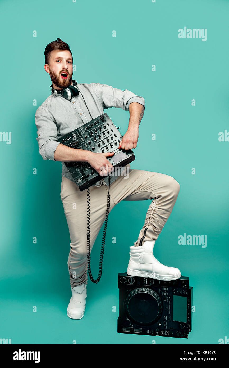 Young male holding mixing console Stock Photo - Alamy