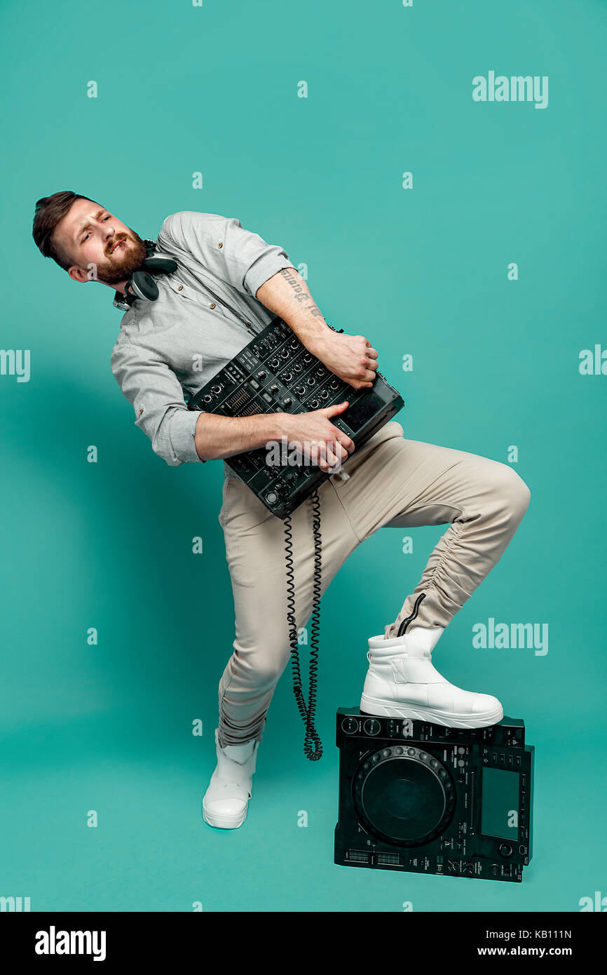 Young male holding mixing console Stock Photo - Alamy