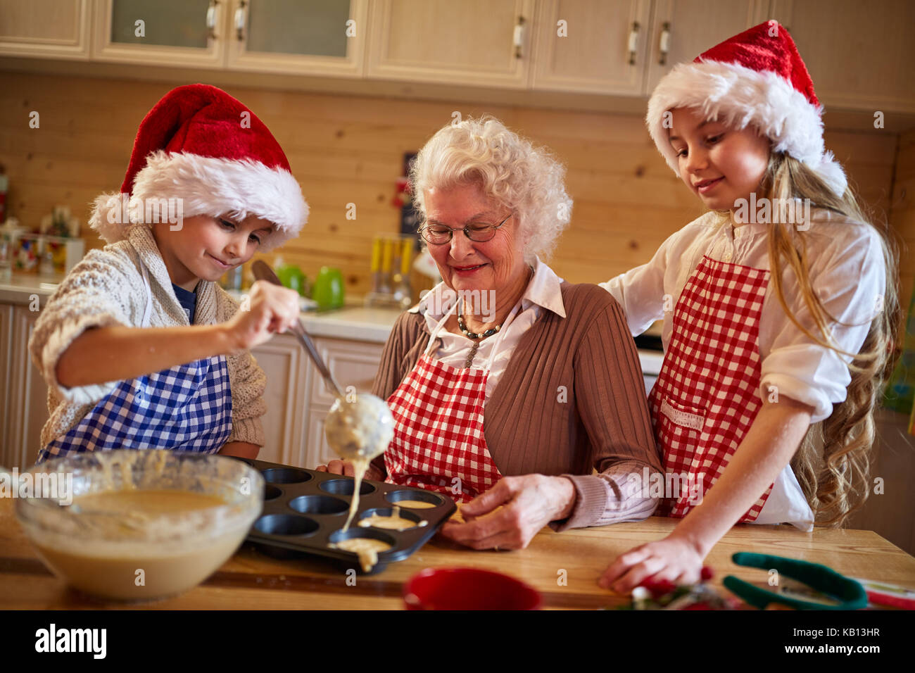 kids baking cookies with grandmother on xmas time Stock Photo