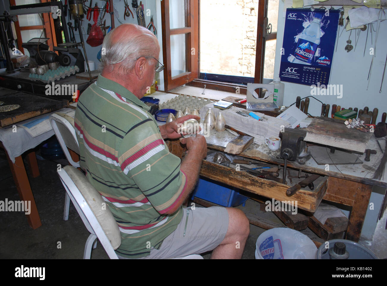 A Cypriot Lefkara born craftsman working in a silver shop in the small Cypriot village Lefkara in Cyprus Stock Photo
