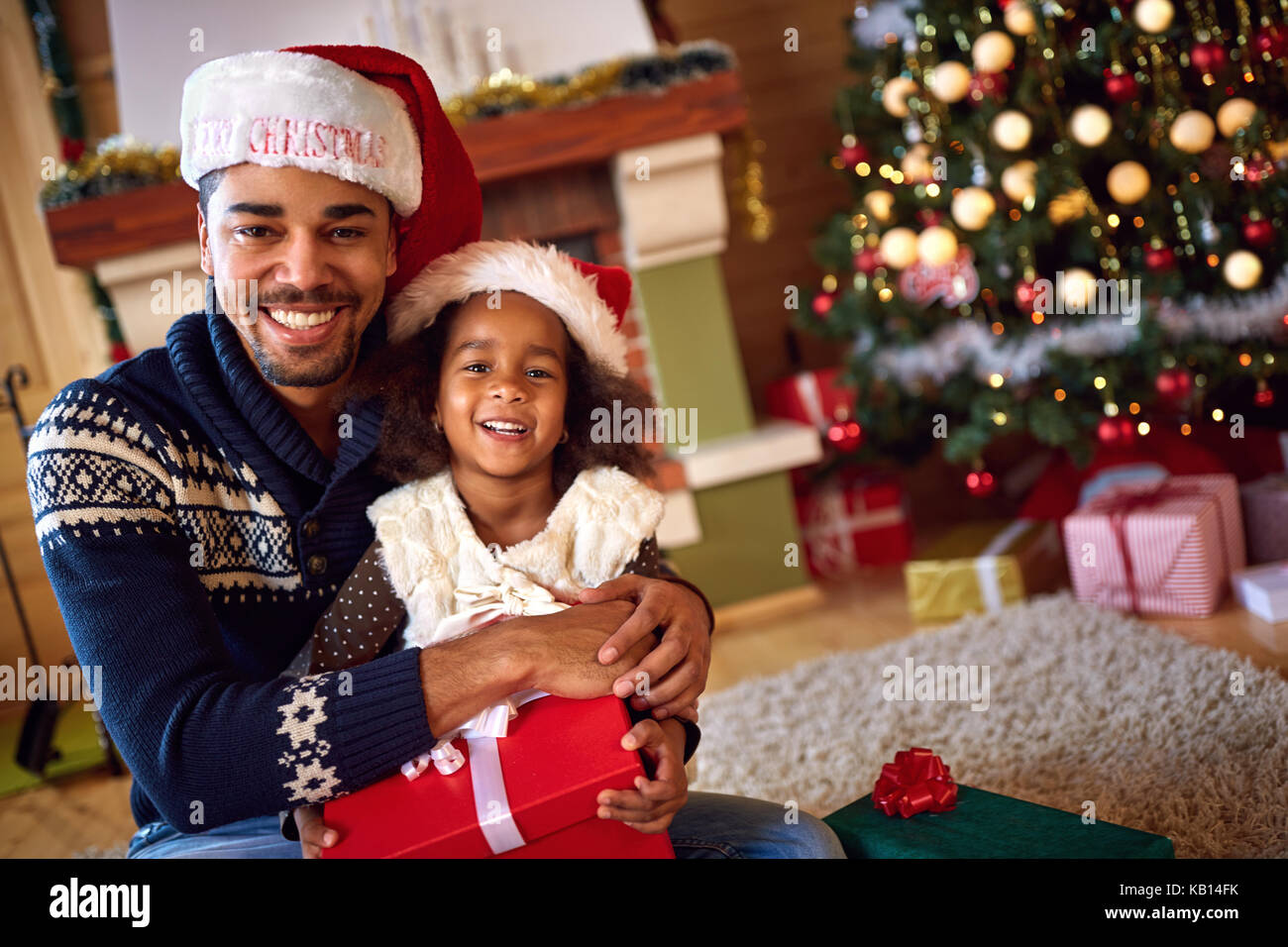 Afro American father with cute cheerful daughter for Christmas eve Stock Photo