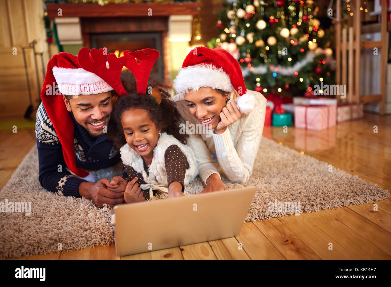 Afro American family use laptop for Christmas online shopping Stock Photo