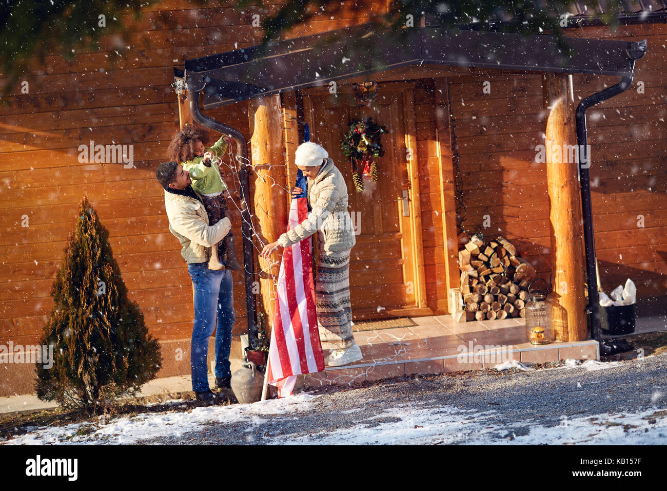 Afro American family decorate his wooden house for Christmas Stock Photo