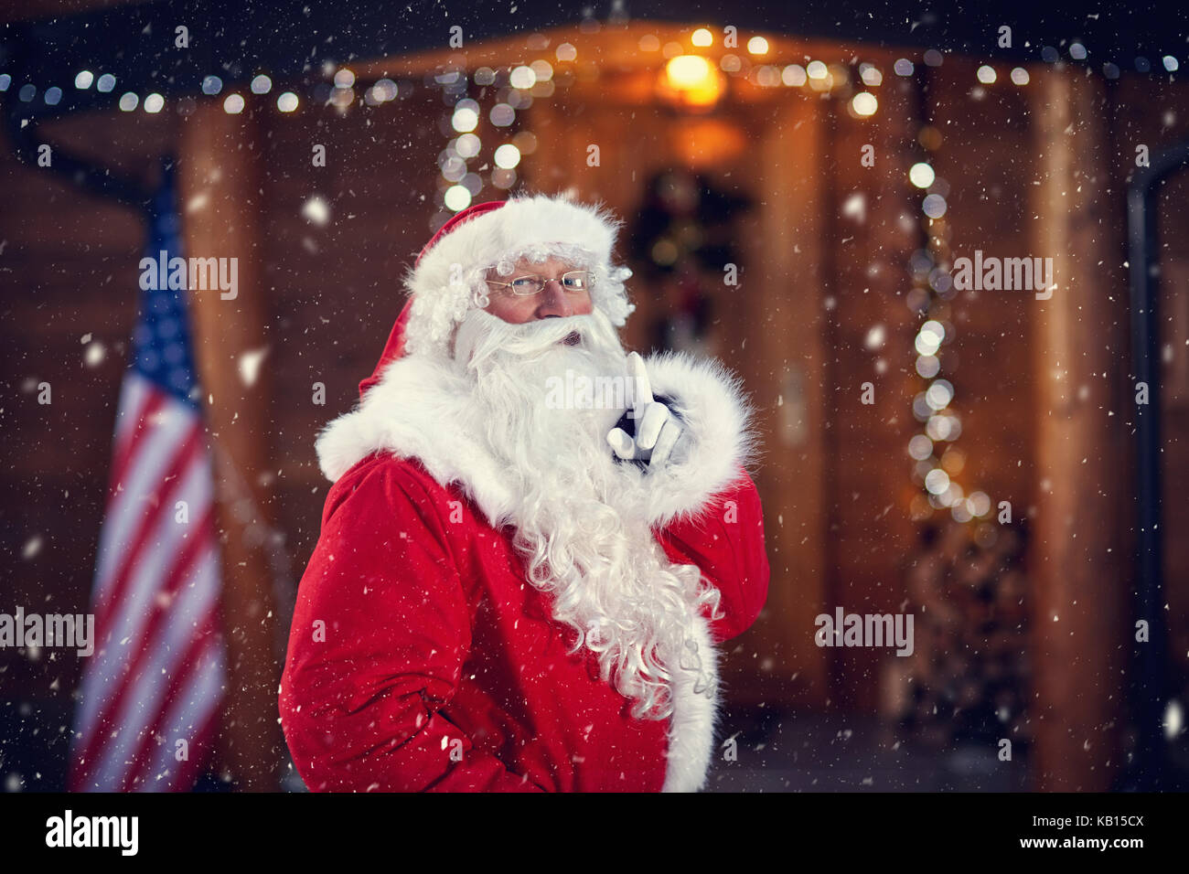 Santa Claus holding finger on mouth, requires silence for mystical Christmas Eve Stock Photo