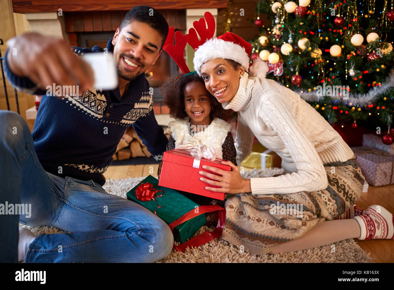 Happy Afro American family making selfie for Christmas holiday Stock Photo