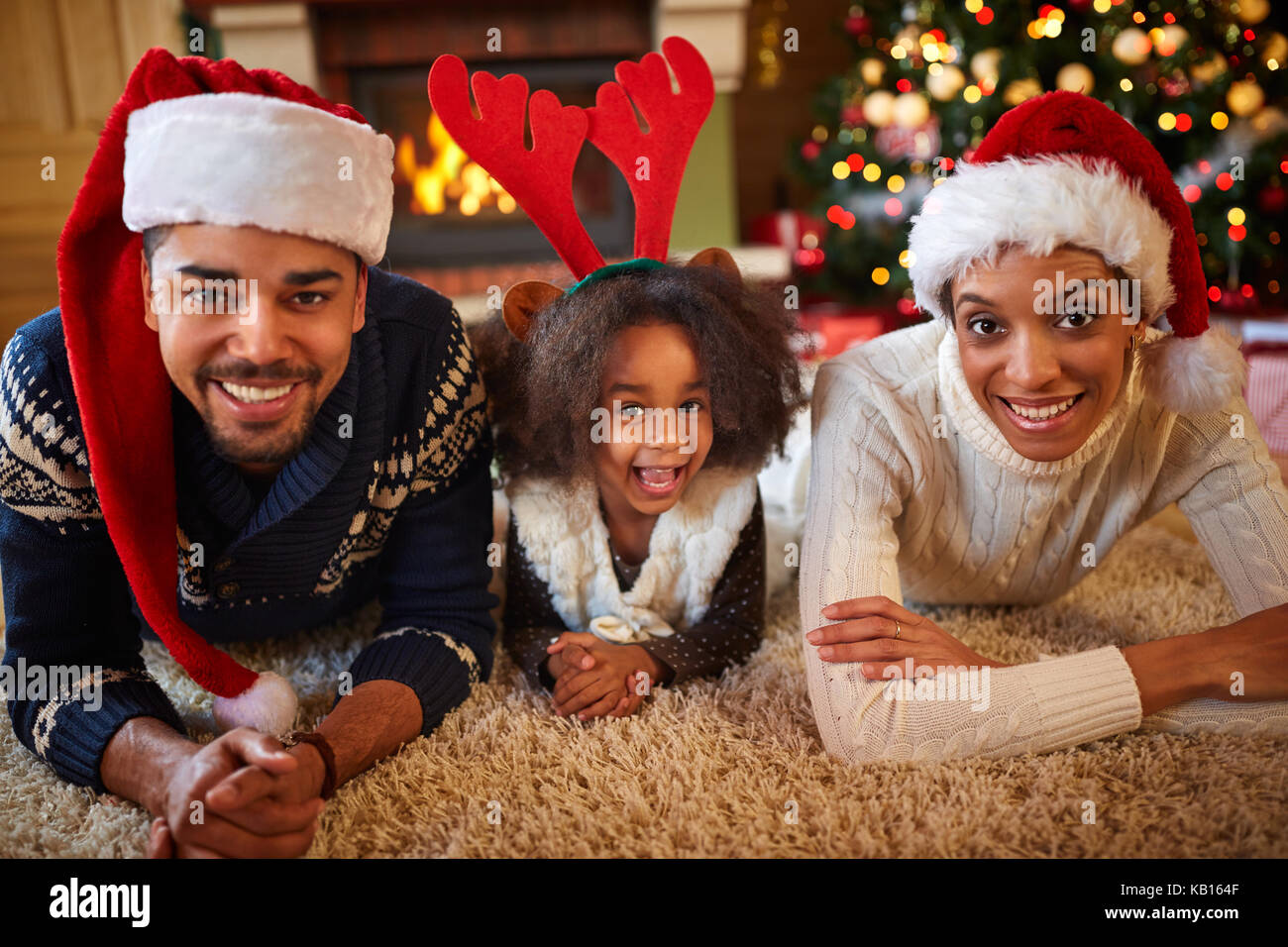 Happy African American family with Santa hats in Christmas atmosphere Stock Photo