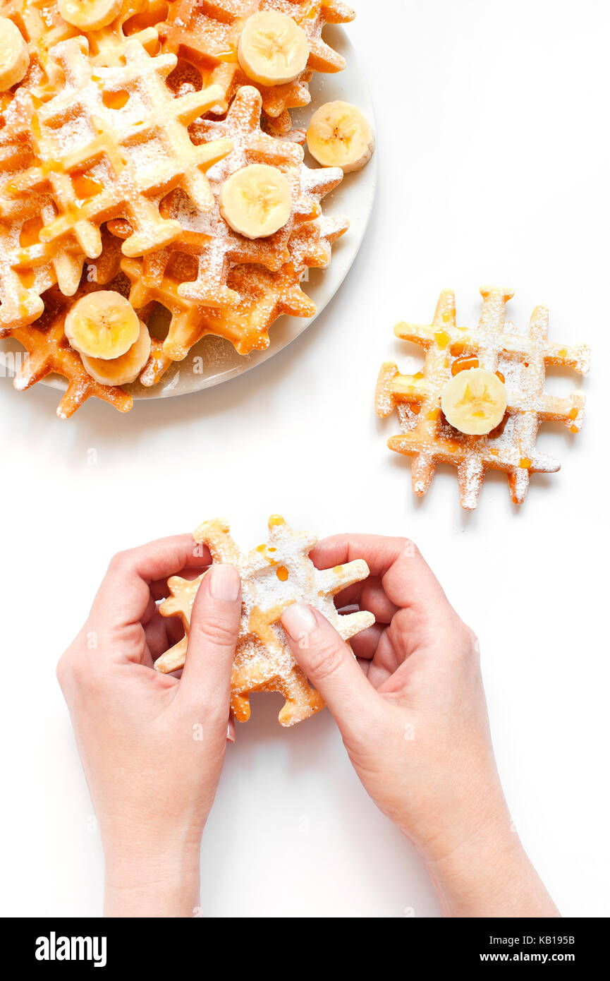 Female hands holding the fresh homemade waffles Stock Photo