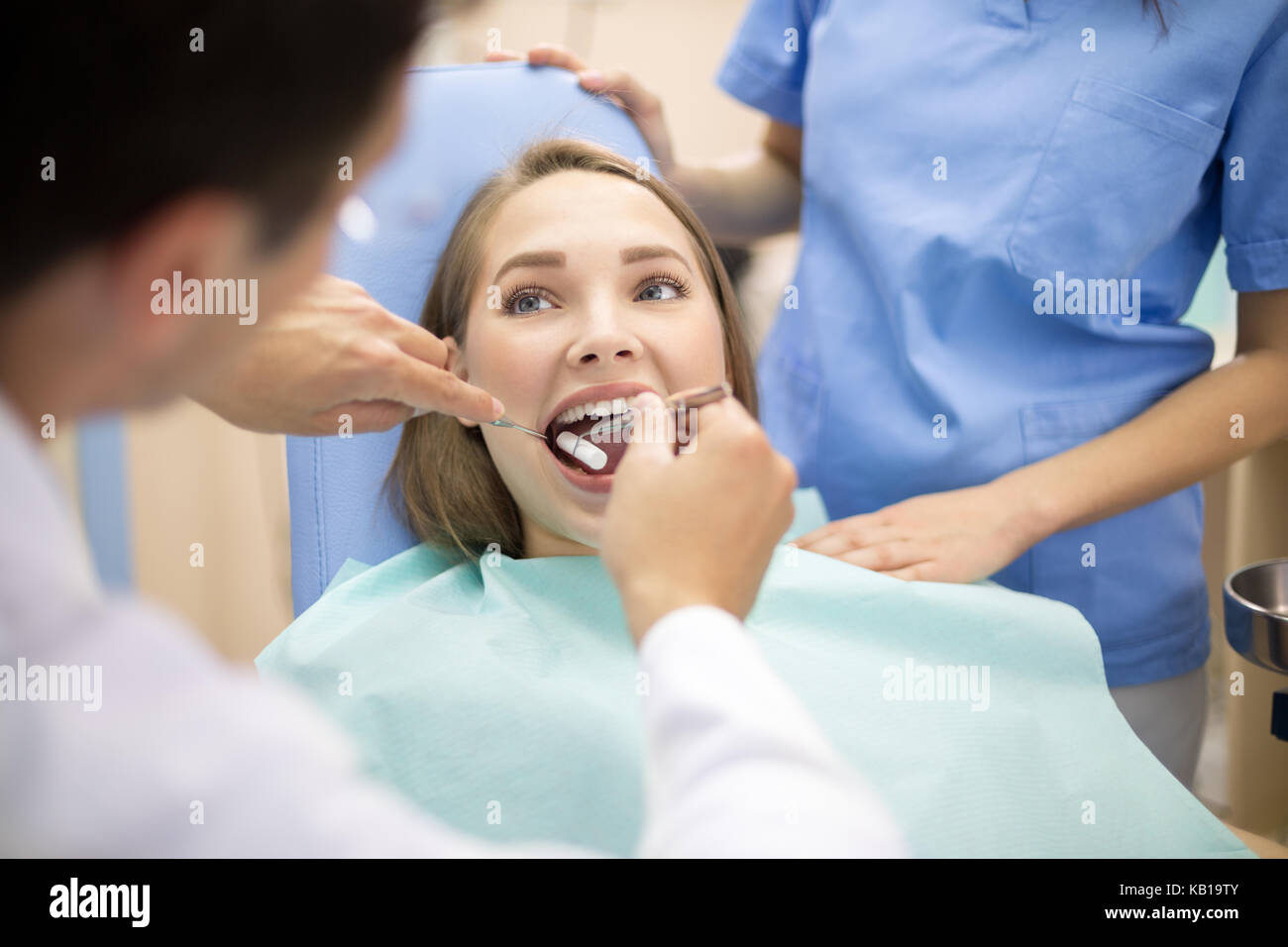 Dentist put cotton pad in patient mouth Stock Photo Alamy