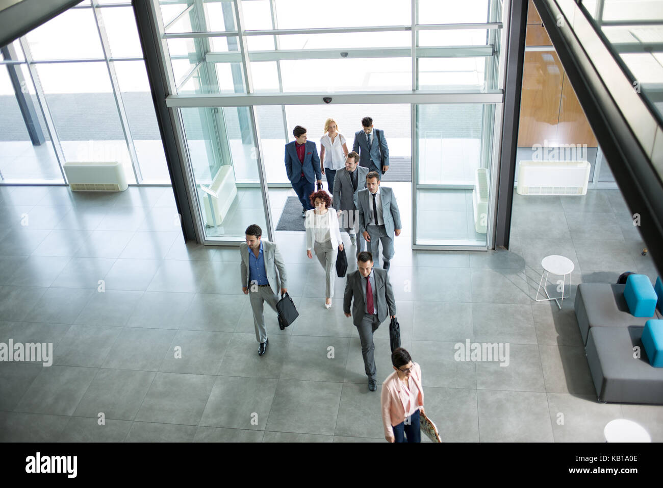Group of professional business people walking on the way in building Stock Photo