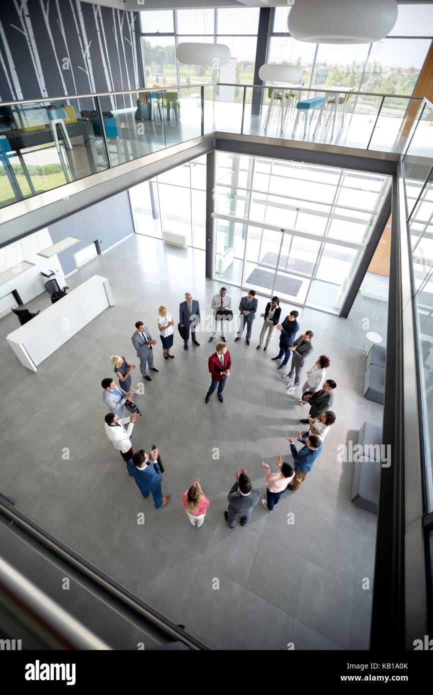 Top view of businessman with team in circle in company hall Stock Photo