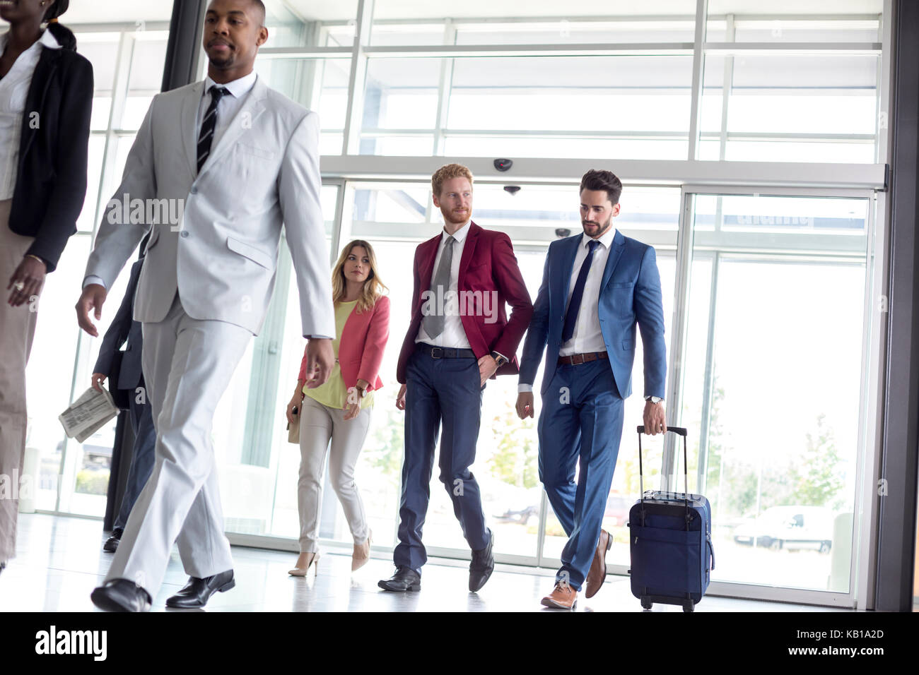 Young multiethnic international tourists arrive in airport waiting room Stock Photo